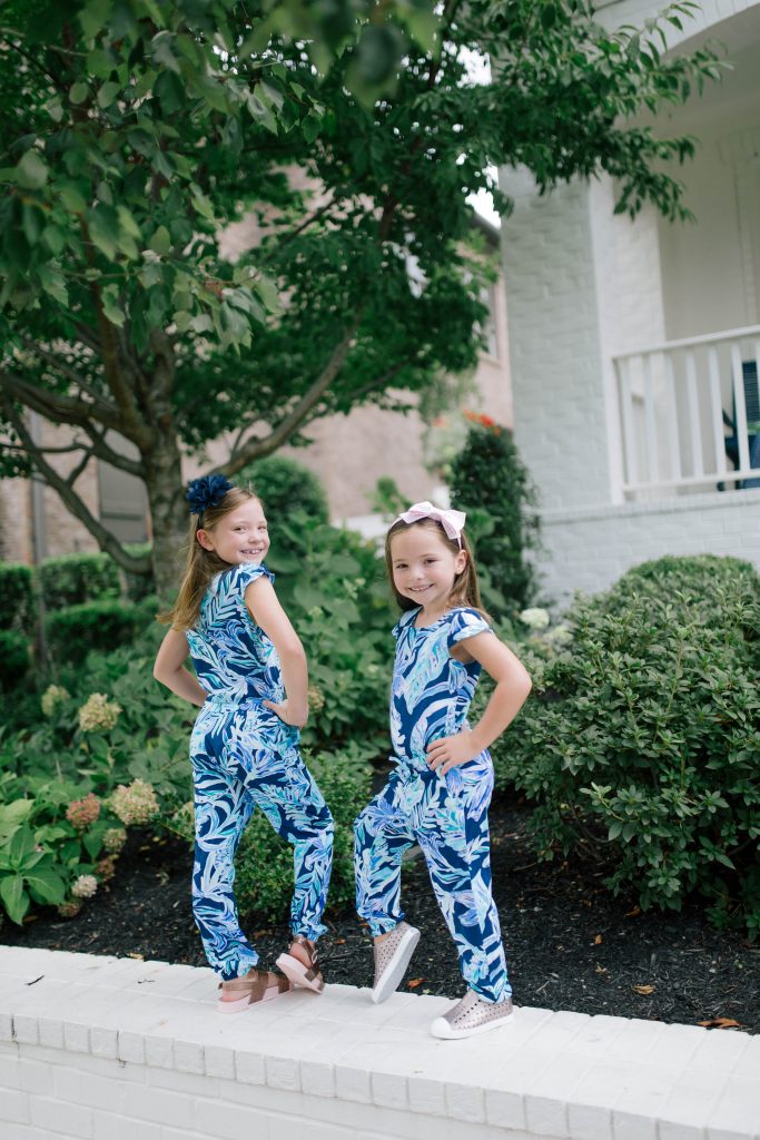 Raising Worry Free Girls by Sissy Goff by popular Nashville life and style blog, Hello Happiness: image of two girls outside wearing Nordstrom Native Shoes Jefferson Bling Glitter Slip-On Vegan Sneaker, Nordstrom Mel by Melissa Cosmic Sandal, and Lilly Pulitzer GIRLS ODESSA JUMPSUIT.
