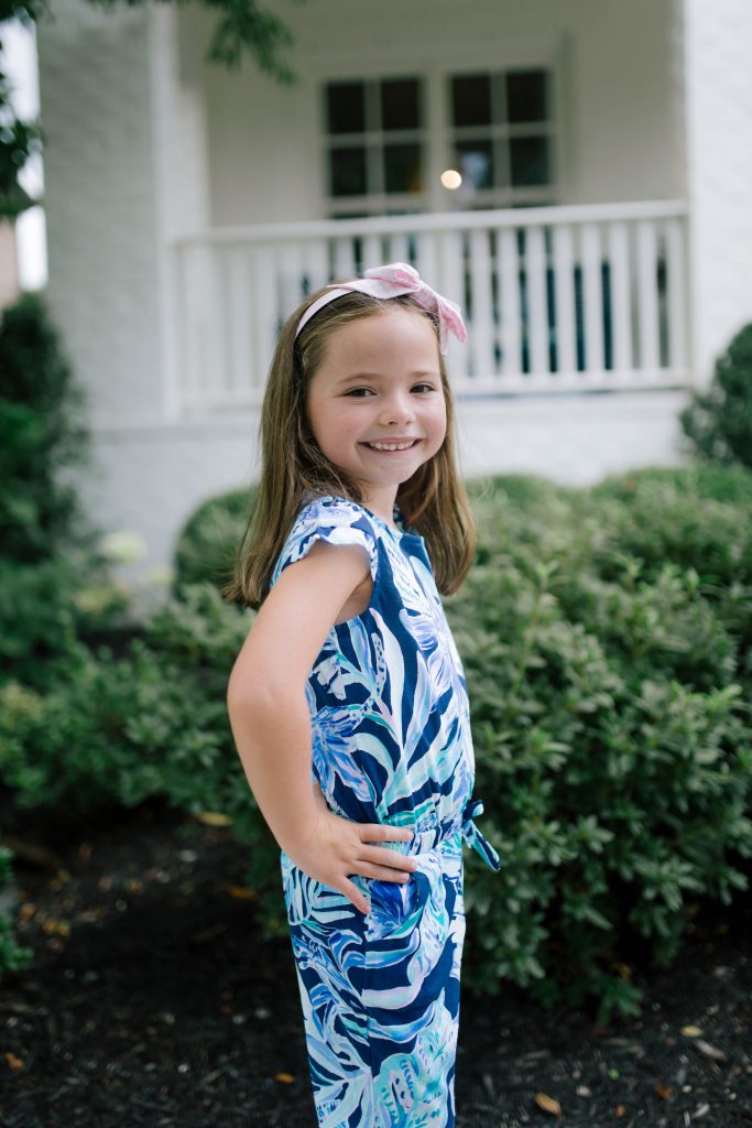 Raising Worry Free Girls by Sissy Goff by popular Nashville life and style blog, Hello Happiness: image of a girl outside wearing Nordstrom Mel by Melissa Cosmic Sandal, and Lilly Pulitzer GIRLS ODESSA JUMPSUIT.