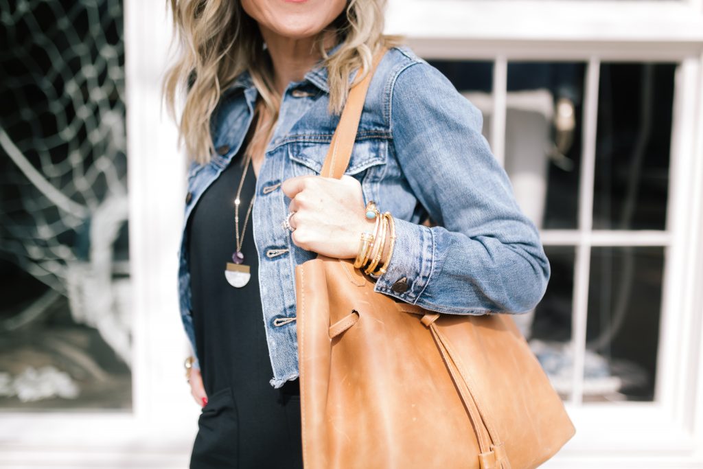 ABLE featured by top US fashion blog Hello! Happiness; Image of a woman wearing a black jumpsuit and purse from ABLE