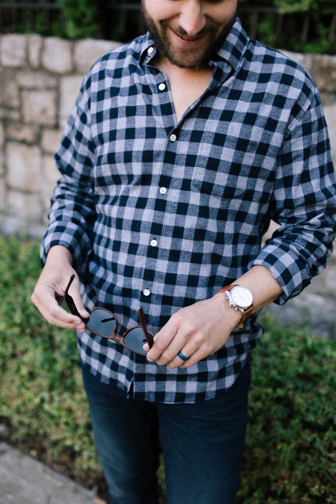 2019 holiday gift guide | Best Gifts for Him by popular Nashville life and style blog, Hello Happiness: image of a man who is wearing a Bonobos Brushed Button-Down Shirt, Bonobos Stretch Eco Jeans, and Nordstrom Ray-Ban Standard Classic Wayfarer 50mm Polarized Sunglasses.