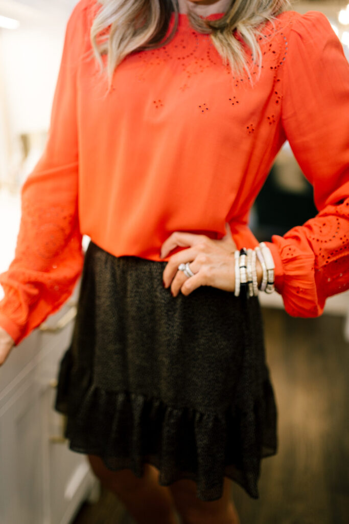 Valentine's Day Gifts by popular Nashville life and style blog, Hello Happiness: image of Natasha Stoneking wearing an embroidered Loft shirt, Loft flecked twirl skirt and gold stack bracelets. 