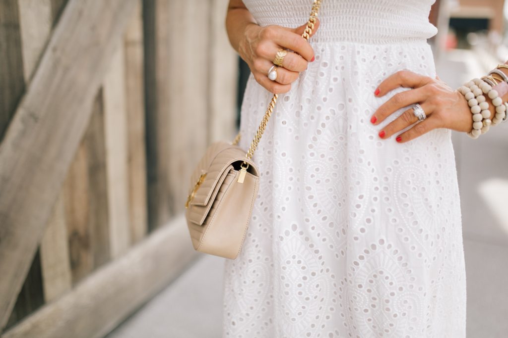 Pretty Pink Lily Favorites...by popular Nashville fashion blog, Hello Happiness: image of a woman wearing a Pink Lily Promise in My Heart Dress, Sulpice Small Crossbody, and Willa Ford Pink and Yellow Geometric Earrings.