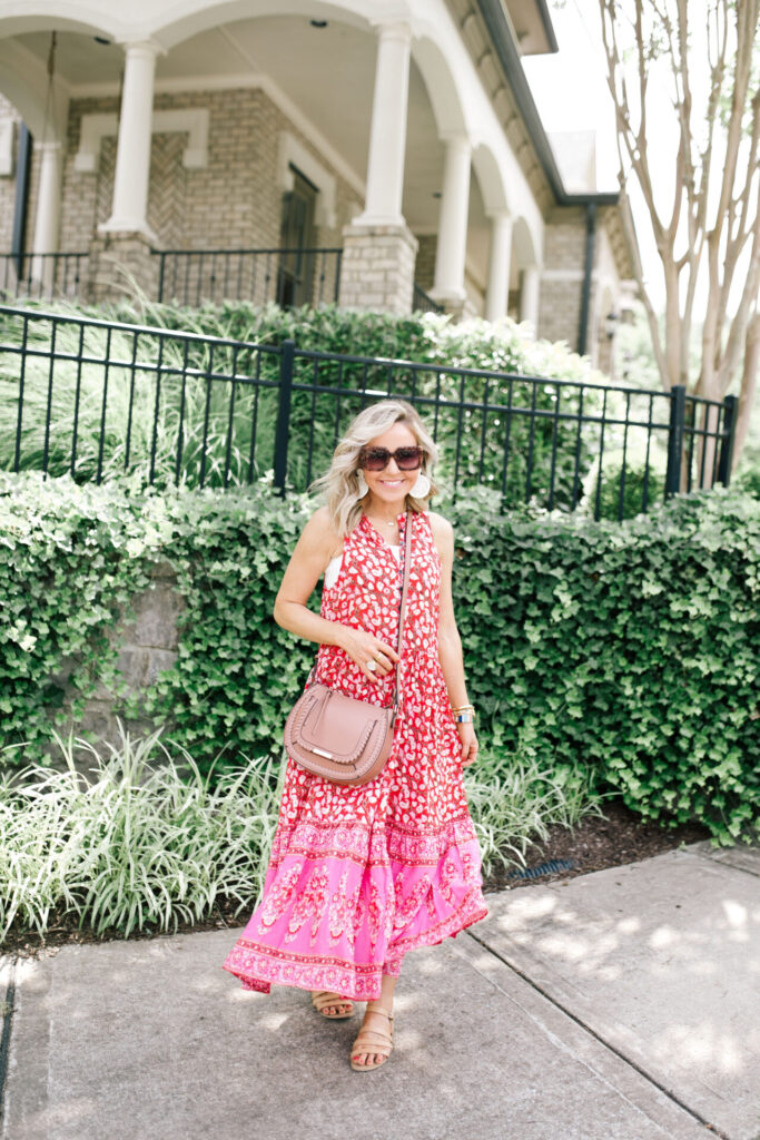 Amazon Favorites by popular Nashville life and style blog, Hello Happiness: image of a woman standing outside and wearing a red and pink floral maxi dress. 