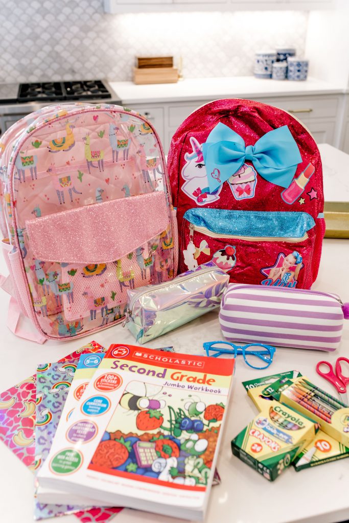 Trend Setting Back-to-School Outfits from Walmart by popular Nashville fashion blog, Hello Happiness: image of school supplies next to Walmart Wonder Nation Clear Kids Backpack and Jo Jo Siwa Be You! Backpack.