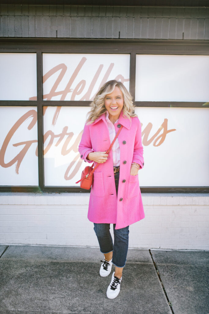 J. Crew Holiday by popular Nashville fashion blog, Hello Happiness: image of Natasha Stoneking standing outside and wearing a J. CrewDemi Boot Dark Jeans, Striped Poplin Shirt, Pink Lady Wool Coat, and Saturday Sneakers with Leopard Detail.