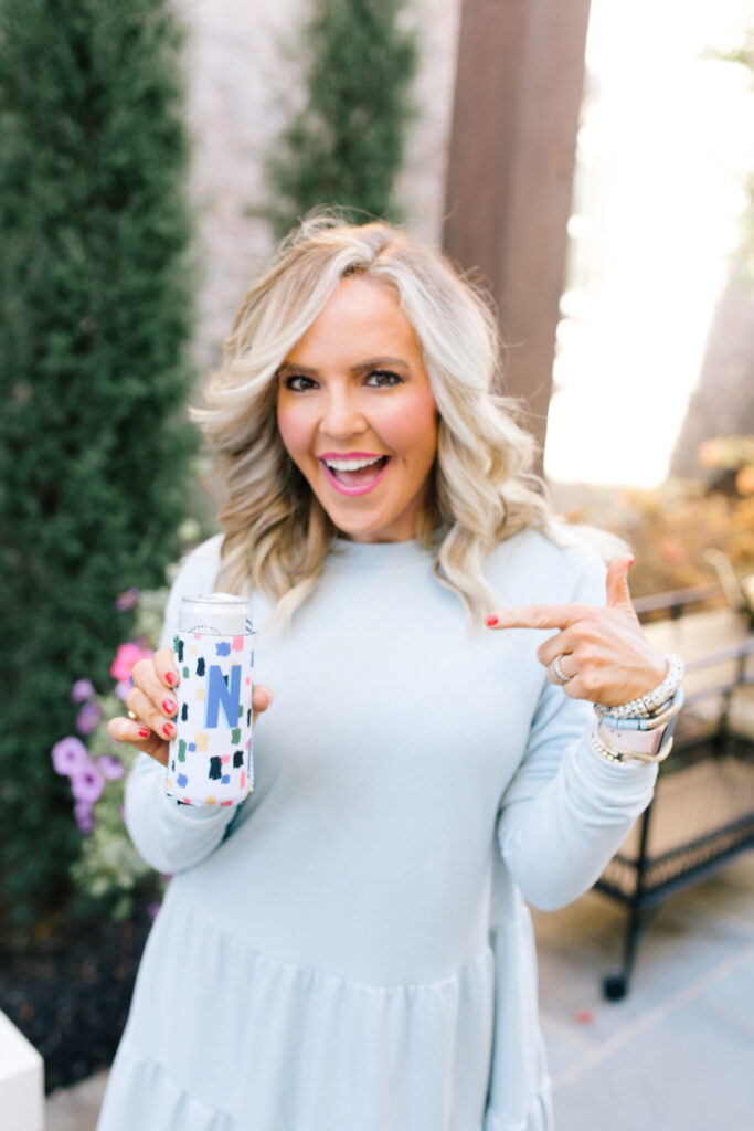 Clairebella Studio by popular Nashville life and style blog, Hello Happiness: image of Natasha Stoneking holding a Clairbella Studio and Hello Happiness can cooler. 