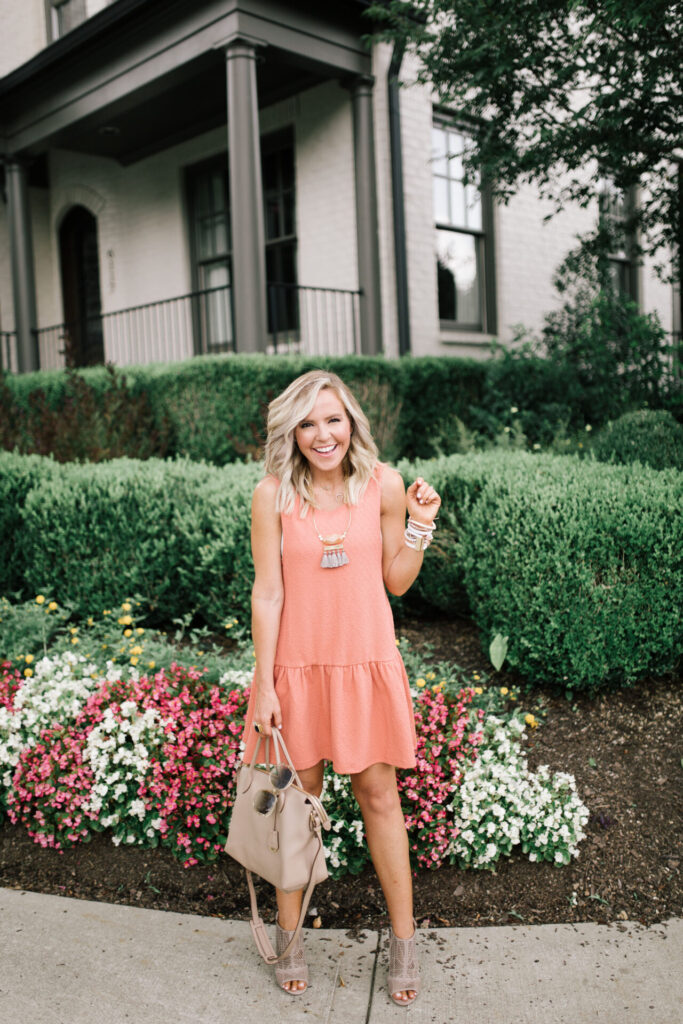 Personal Questions by popular Nashville lifestyle blog, Hello Happiness: image of Natasha Stoneking wearing a peach colored tier dresss and heel sandals. 