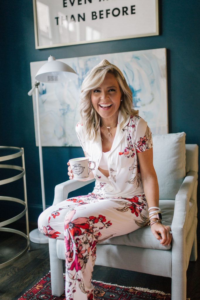 Pajama Time: Soma Friends and Family Sale by popular Nashville life and style blog, Hello Happiness: image of a woman sitting on a grey chair and wearing a Soma COOL NIGHTS Short Sleeve Grosgrain Trim Notch Collar Pajama Top Floral Affair, Soma COOL NIGHTS Grosgrain Trim Pajama Pants Floral Affair, and ENBLISS Wireless Bralette.