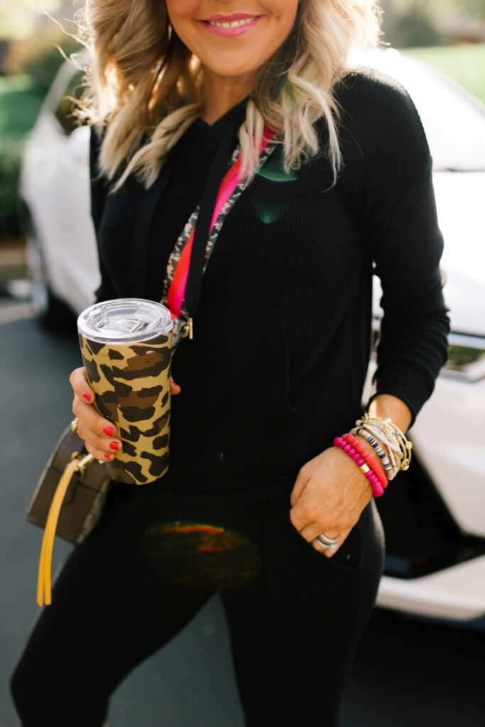 Cyber Monday Sale by popular Nashville life and style blog, Hello Happiness: image of Natasha Stoneking wearing an all black outfit and leopard print thermos. 