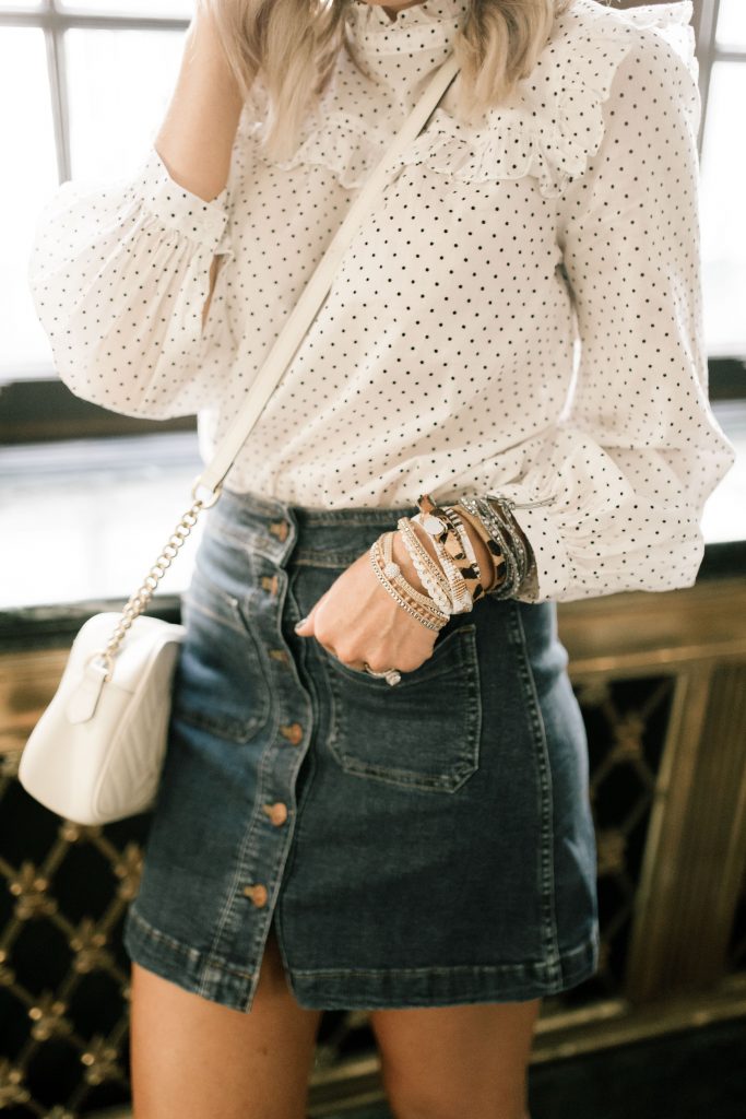 My Favorite Arm Candy...The BOGO Victoria Emerson Sale by popular Nashville fashion blog, Hello Happiness: image of a woman wearing a Victoria Emerson GOLD ATTICA stack, Victoria Emerson DOUBLE WRAP ON SAFARI TEXTURED LEATHER bracelet, Victoria Emerson SILVER DORADO AND MINT GREEN ON SILVER stack, Madewell denim mini skirt, Madewell Mockneck Ruffle Top in Flocked Dot, and Nordstrom Gucci Small GG Marmont 2.0 Matelassé Leather Camera Bag