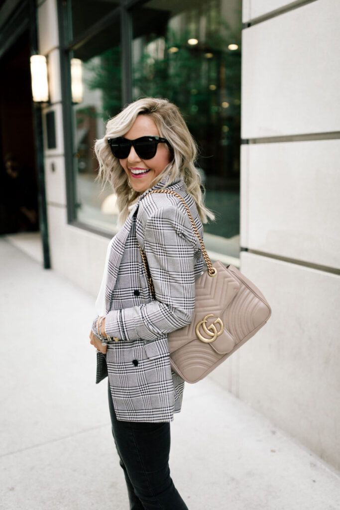 Nordstrom Anniversary Sale by popular Nashville fashion blog, Hello Happiness: image of Natasha Stoneking wearing a black and white plaid blazer, balck jeans, black sunglasses, and holding a Gucci purse. 