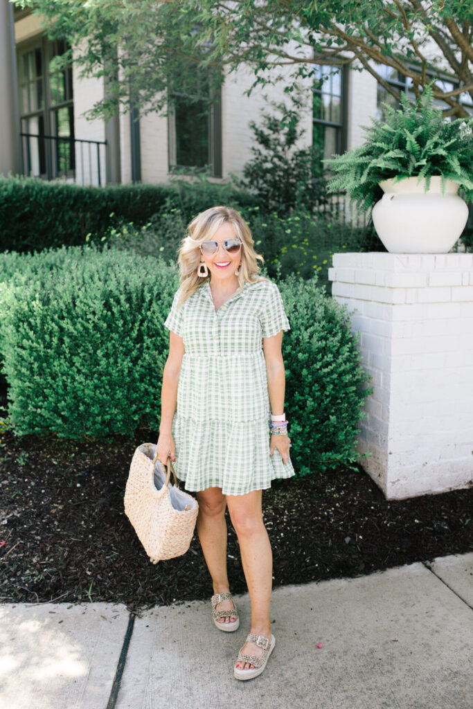 Independence Day Deals by popular Nashville life and style blog, Hello Happiness: image of Natasha Stoneking wearing Sole Society VANYAH BUCKLE FLATFORM SLIDE, Urban Outfitters UO Chapin Mini Shirt Dress, and holding a Sole Society ELISE TOTE STRAW TOTE.
