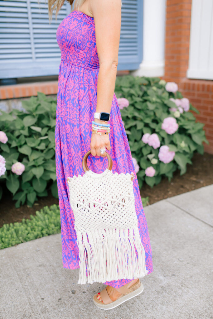 Walmart Scoop by popular Nashville fashion blog, Hello Happiness: image of a woman standing outside and wearing a Walmart Scoop Women’s Smock Top Strapless Printed Maxi Dress, Walmart Quay Women's Gradient Breeze In QW-000378-GLD/BRN Gold Geometric Sunglasses, Walmart Scoop Macrame Wooden Handle Tote Bag, and Walmart Wodstyle Womens Platform Espadrille Sandals Buckle Peep Toe Summer Casual Shoe.