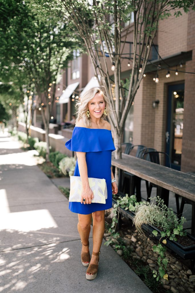 Ready, Set, SHOP! The Best in 4th of July Sales by popular Nashville fashion blog, Hello Happiness: image of woman standing outside on a city sidewalk wearing Adalyn Wedge Espadrilles and Sincerely Jules Twist Flirt Jumpsuit by BILLABONG