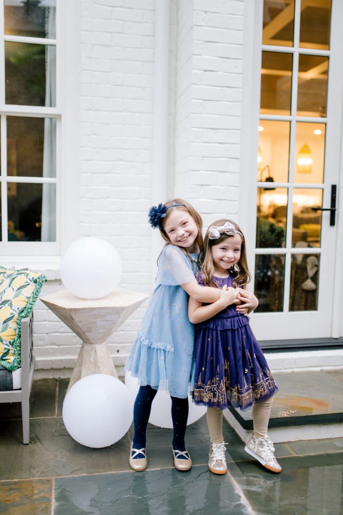 2019 Holiday Gift Guide | 2019 Holiday Gift Guide | Best Cyber Week Sales and Deals by popular Nashville life and style blog, Hello Happiness: image of two girls outside wearing a Boden Hogwarts Enchanted Tulle Dress and Boden Patronus Party Dress.