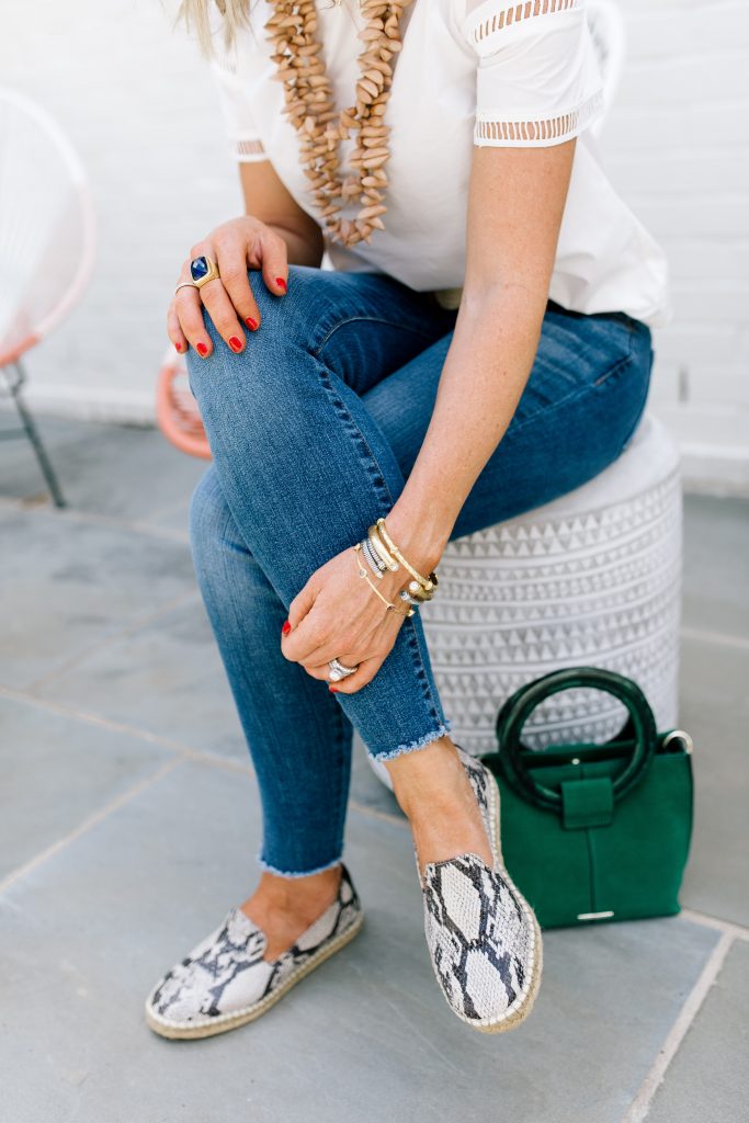Snakeskin + Leopard...My Vince Camuto Favorites by popular Nashville blog, Hello Happiness: image of a woman sitting outside next to her Vince Camuto Iggy Ring Handle Crossbody Bag and wearing Jorrla Espadrille Flats. 