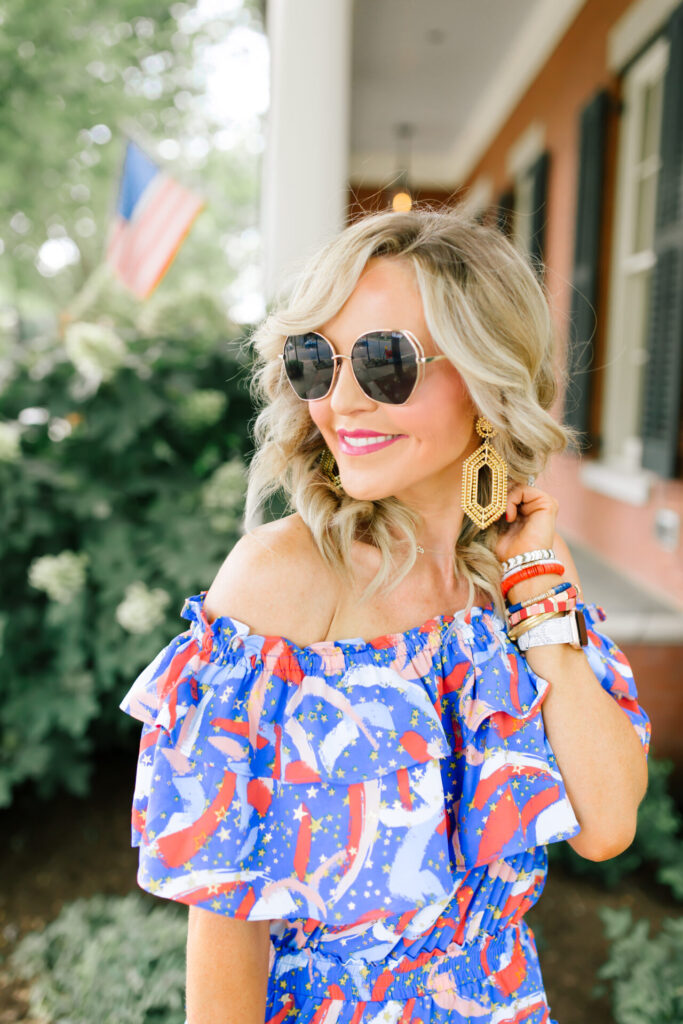 Independence Day Deals by popular Nashville life and style blog, Hello Happiness: image of Natasha Stoneking wearing a Buddy Love Kiera Fireworks dress, gold earrings, and big love sunglasses. 