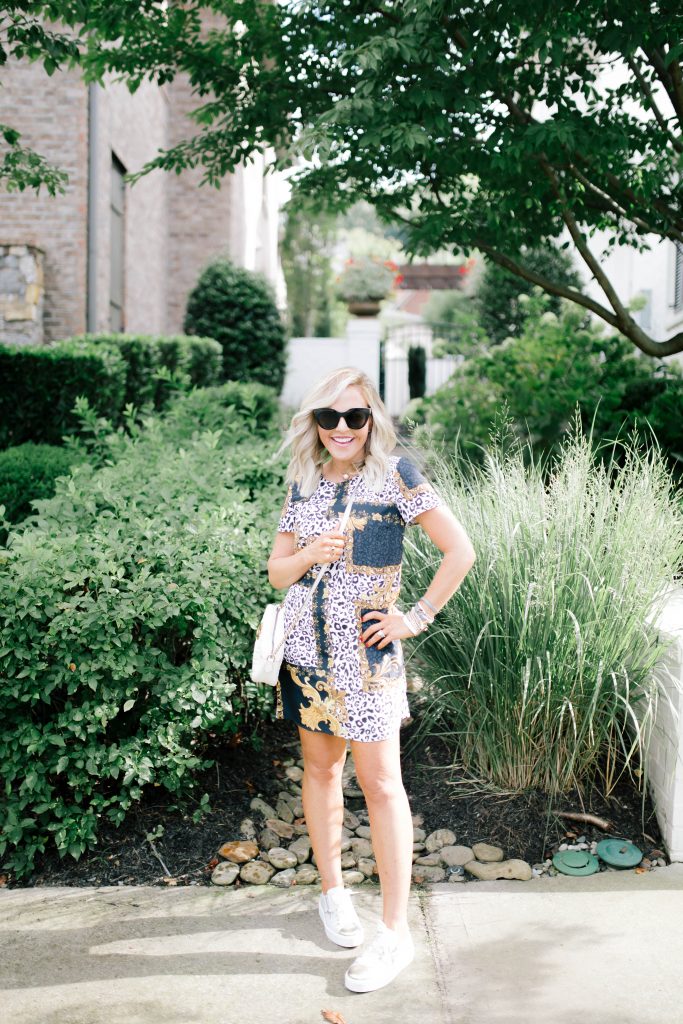 Stock Up...It's Fall Sneakers Season by popular Nashville fashion blog, Hello Happiness: image of a woman standing outside and wearing Fratinardi NEROGIARDINI TRAINERS, Material Girl TShirt Dress, Gucci Small Marmont Crossbody, It's My Way Sunglasses, Daisy Pearl Necklace, Grey Double Wrap Bracelet, Boho Wrap Bracelet.