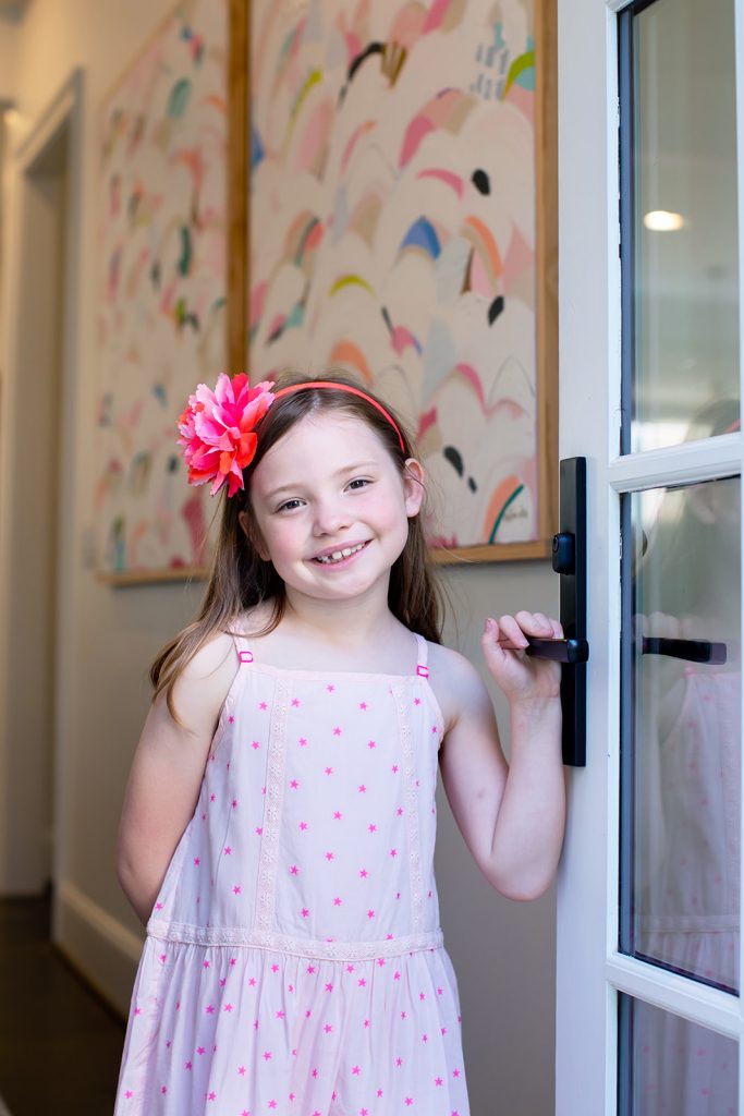 Happy 8th Birthday Daughter by popular Nashville lifestyle blog, Hello Happiness: image of a little girl wearing a pink star dress and pink flower headband. 