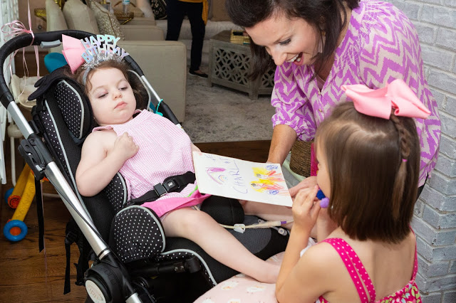 Giving JOY and Kindness for Charlotte... Spread the Love on July 31st with Smidge of This by popular Nashville lifestyle blog, Hello Happiness: image of a mom showing a hand drawn picture to her daughter that has Leukodystrophy.