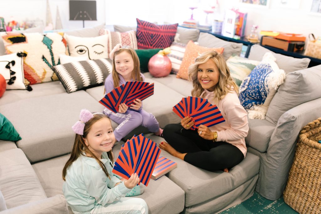 Everything Holiday with Academy Sports + Outdoors Gifts by popular life and style blog, Hello Happiness: image of a mom and her two daughters playing with a giant deck of Academy Sports + Outdoors giant playing cards.