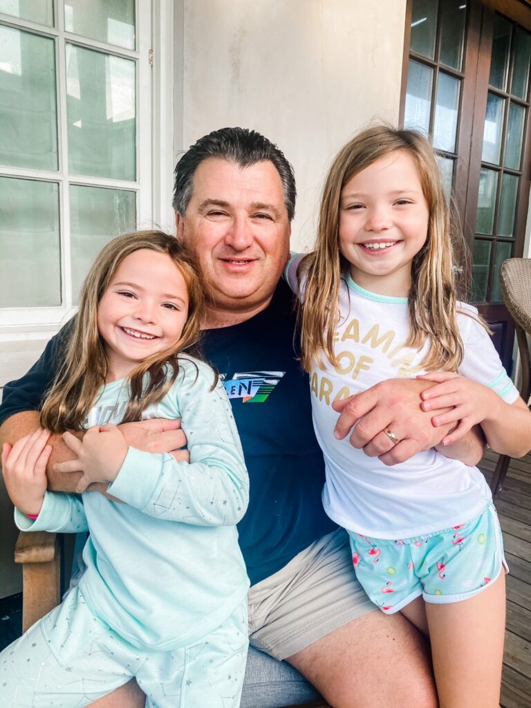 Rosemary Beach by popular Nashville travel blog, Hello Happiness: image of two young girls standing with their grandpa. 