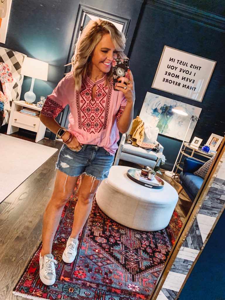My Current Amazon Favorites by popular Nashville fashion blog, Hello Happiness: image of a woman standing in her room and wearing a Mansy Women's Summer V Neck Boho Print Embroidered Shirts Short Sleeve Casual Tops Blouse. 