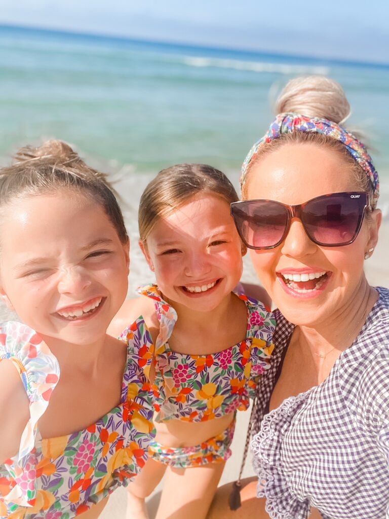 Rosemary Beach by popular Nashville travel blog, Hello Happiness: image of Natasha Stoneking standing with her two daughters on the beach. 
