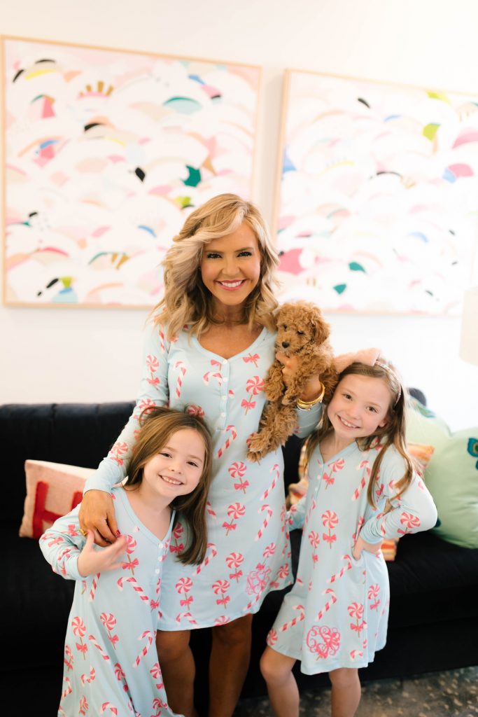 Life with Tucker + The Best Pet Gifts by popular life and style blog, Hello Happiness: image of a mom and her two daughters holding their goldendoodle puppy and wearing I Love Jewelry MONOGRAM CANDY LAND NIGHTGOWNS. 