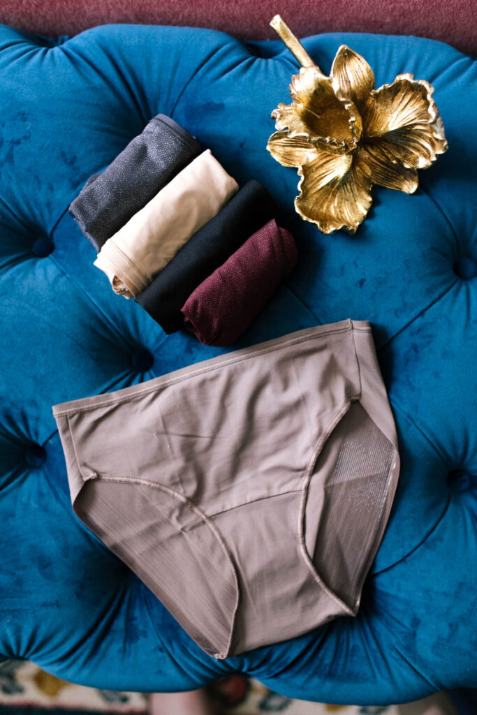 Soma Sale by popular Nashville lifestyle blog, Hello Happiness: image of Soma underwear on a tuft velvet bench. 
