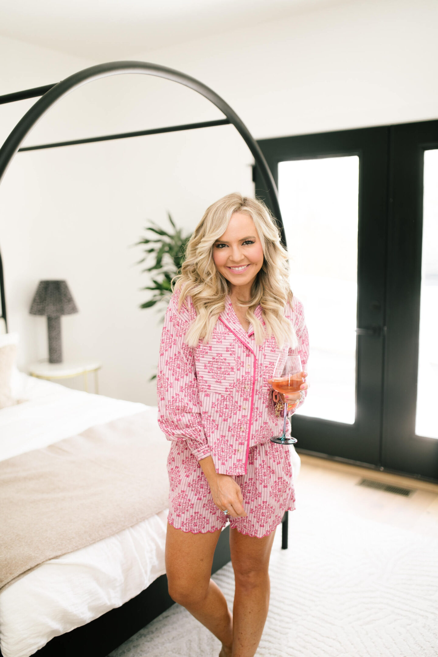 Anthropologie Sale by popular Nashville life and style blog, Hello Happiness: image of Natasha Stoneking wearing a pink pajama set and holding a wine glass. 