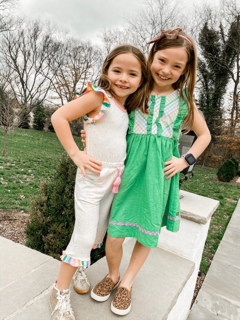 Winter to Spring Essentials by popular Nashville fashion blog, Hello Happiness: image two young girls wearing a Matilda Jane Kindness Romper and Matilda Jane Over The Rainbow Dress.