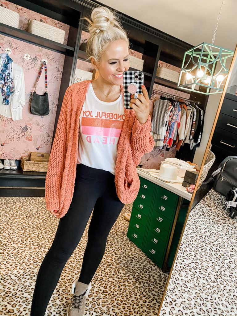 Winter to Spring Essentials by popular Nashville fashion blog, Hello Happiness: image of a woman wearing a Vici ELODIE POCKETED CHENILLE DOLMAN CARDIGAN - APRICOT, Confettees Wonderful Joy Ahead Activewear Tank, Aerie AERIE REAL ME MESH HIGH WAISTED 7/8 LEGGING, and Marc Fisher Davie Sneaker Bootie.