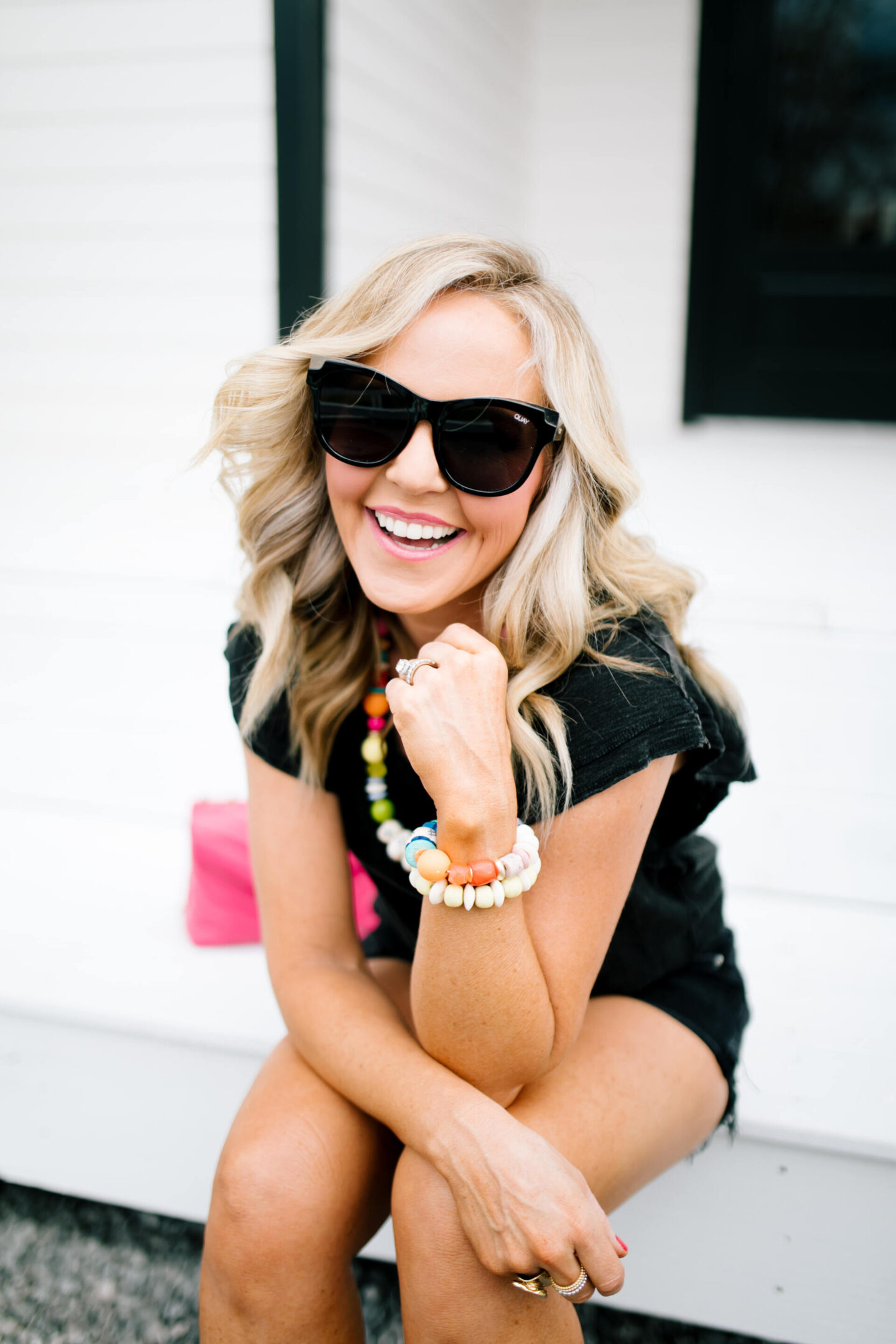 Accessory Concierge by popular Nashville fashion blog, Hello Happiness: image of Natasha Stoneking wearing a Accessory Concierge Wipe Out necklace, Don't Worry Be Happy Bracelet, flutter sleeve tee, and parker shorts. 