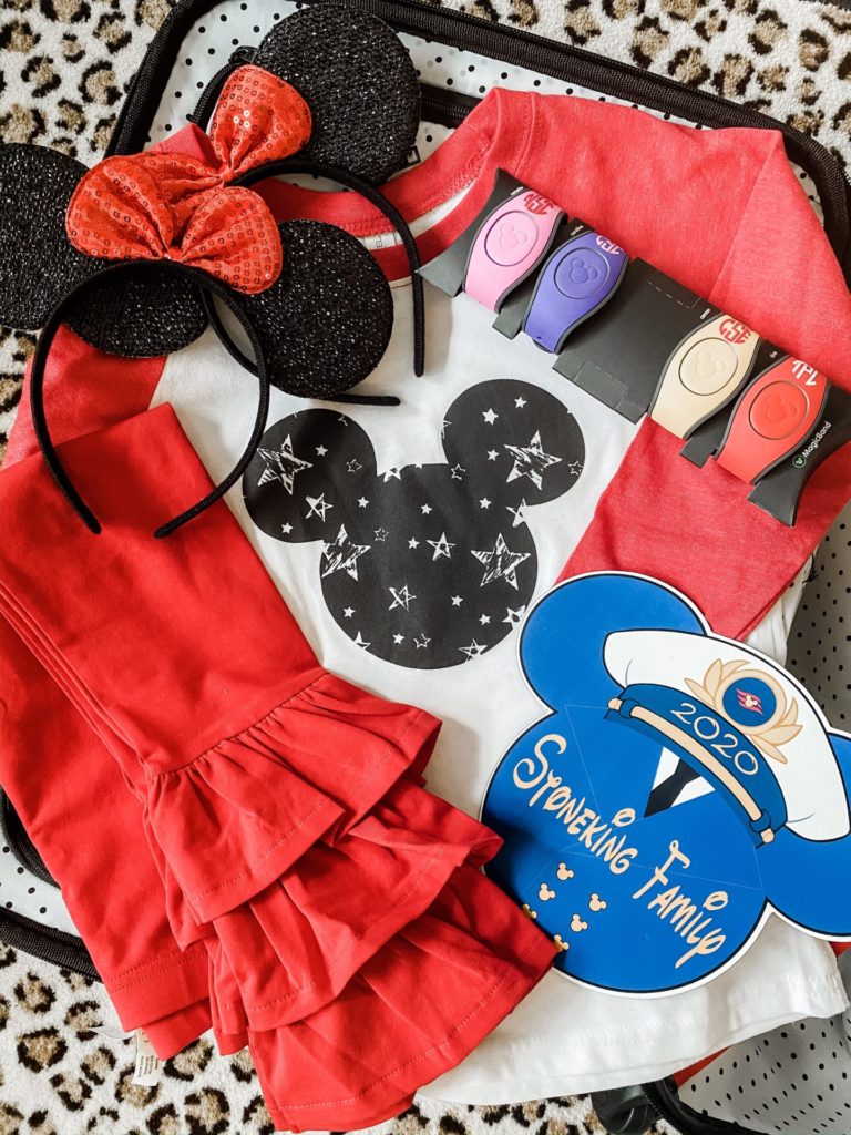 What to Pack for a Disney Cruise by popular US life and style blog, Hello Happiness: image of a Amazon FANYITY 2 Pcs Mouse Ears Headband Hairs Accessories, Little Hoot Starry Mouse, Etsy Mickey & Minnie Monogram Magic Band Decal, Matilda Jane For Your Thoughts Benny, Etsy Disney Cruise Door Magnets, and American Tourister American Tourister Disney Minnie Bows 20" Spinner.