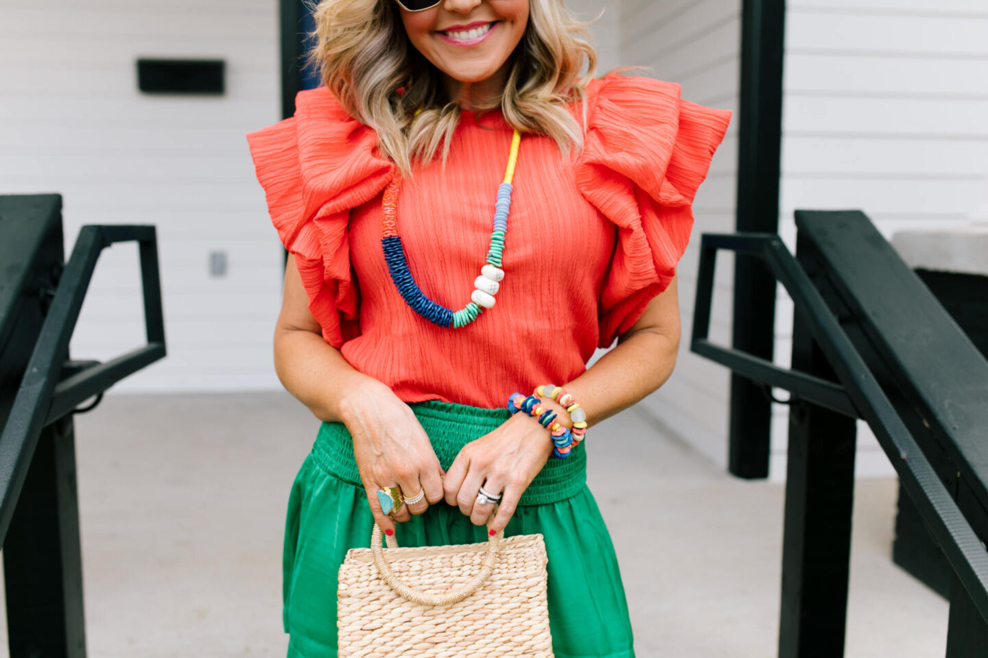 Accessory Concierge by popular Nashville fashion blog, Hello Happiness: image of Natasha Stoneking wearing a Accessory Concierge Lovely Day Necklace, Dock of the Day bracelet, Santeria bracelet, Scarlett top, Laura shorts, espadrille sandals, and holding a Luna bag. 