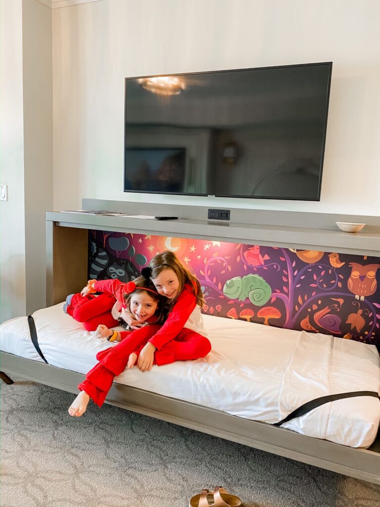 Disney Creators Celebration by popular Nashville lifestyle blog, Hello Happiness: image of two girls sitting on a pullout bed at the Riviera Resort. 