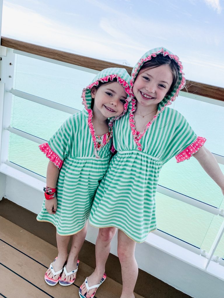 Ready, Set, SHOP! The Best in 4th of July Sales by popular Nashville fashion blog, Hello Happiness: image of two young girls standing outside on a cruise ship deck wearing Matilda Jane Clothing Freestyle Cover-Ups.