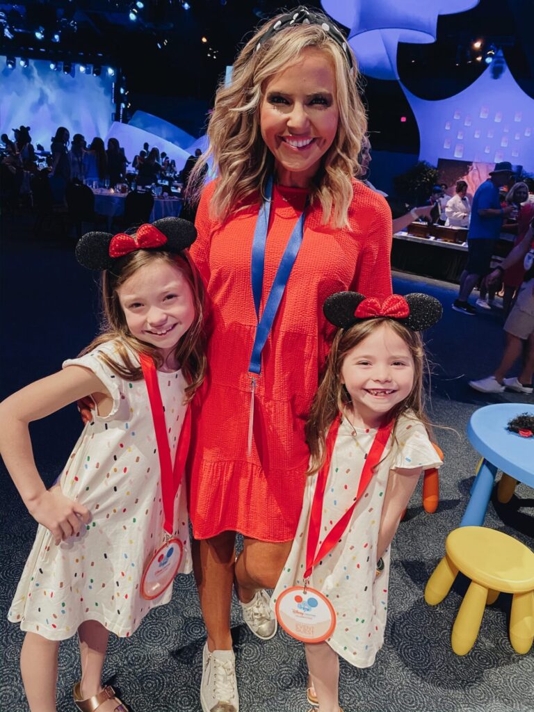Disney Creators Celebration by popular Nashville lifestyle blog, Hello Happiness: image of a mom and her two daughters at Disneyland wearing a Hanna Andersson Flutter Swing Dress, ASOS ASOS DESIGN tiered mini smock dress in seersuckerASOS DESIGN tiered mini smock dress in seersucker, and Amazon Lethez Hairband, Women Polka Dot Bowknot Headband.