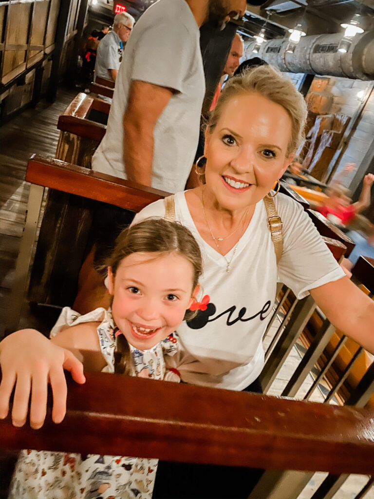 Disney Creators Celebration by popular Nashville lifestyle blog, Hello Happiness: image of a girl and her grandma standing in line for a ride. 