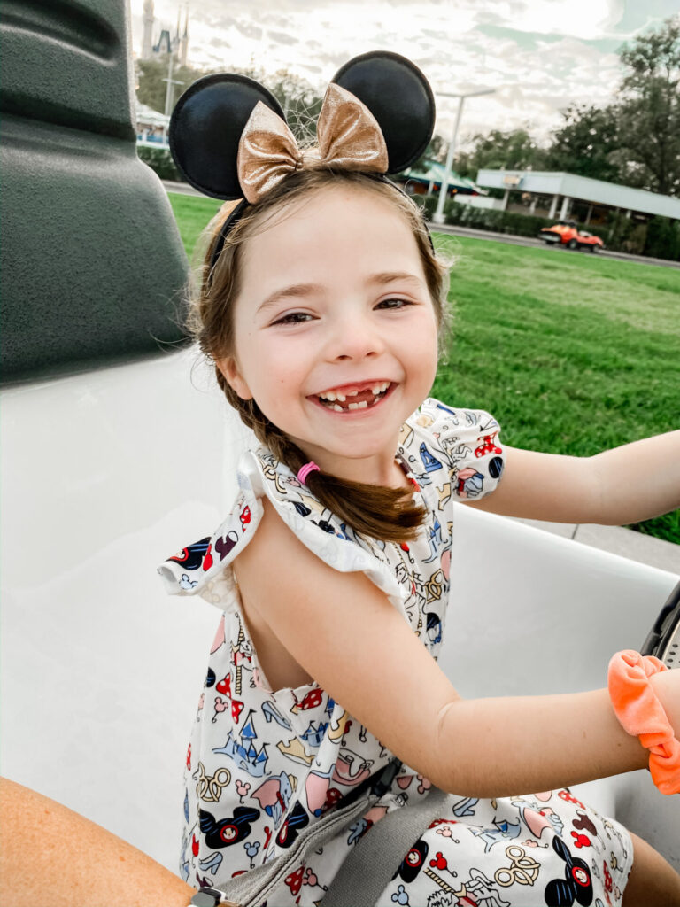 Disney Creators Celebration by popular Nashville lifestyle blog, Hello Happiness: image of a girl on a car ride at Disneyland. 
