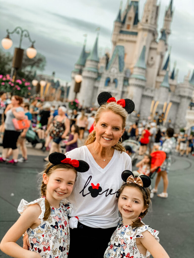 Disney Creators Celebration by popular Nashville lifestyle blog, Hello Happiness: image of two girls standing with their grandma in front of the Disney castle. 