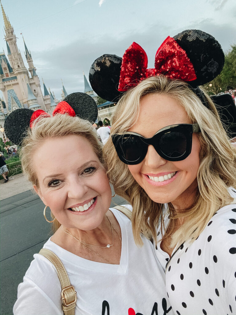 Disney Creators Celebration by popular Nashville lifestyle blog, Hello Happiness: image of Woman and her mother wearing Minnie Mouse ears and standing in front of the Disney castle. 