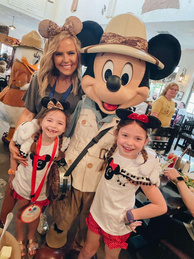 Disney Creators Celebration by poplar Nashville travel blog, Hello Happiness: image of a mom and her two daughters standing with Mickey Mouse. 