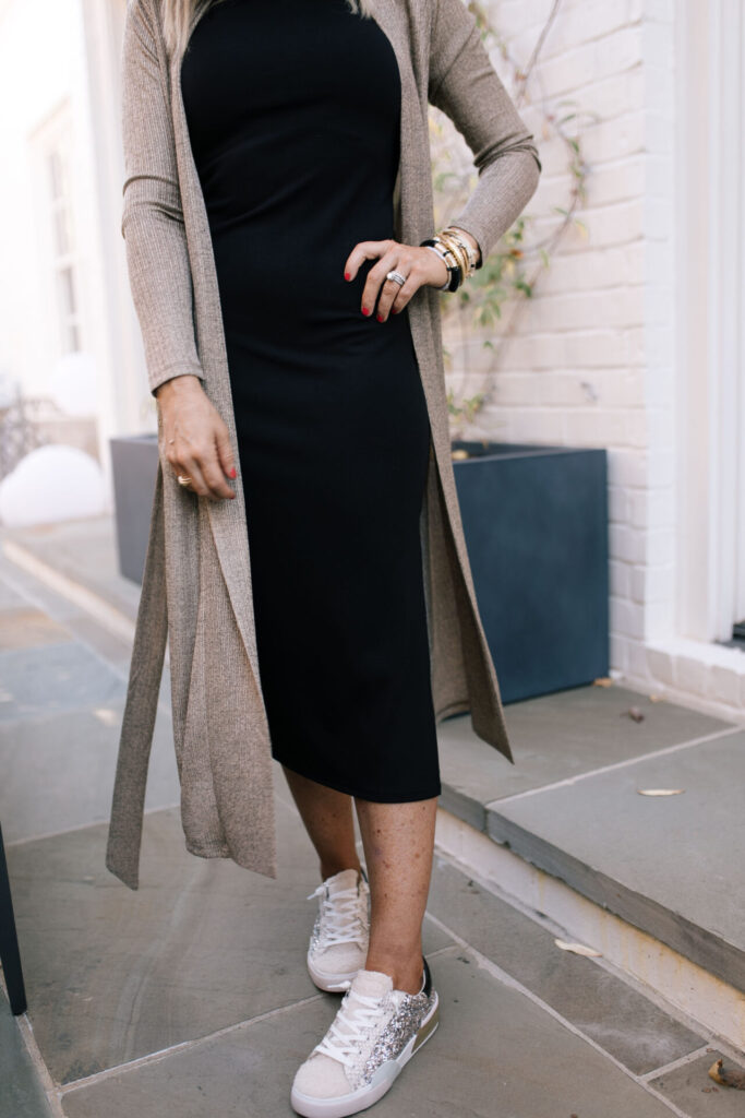 Holiday Collection by popular Nashville fashion blog, Hello Happiness: image of Natasha Stoneking wearing a Gibson x Glam gold duster cardigan, black mock neck midi dress and sequin sneakers. 
