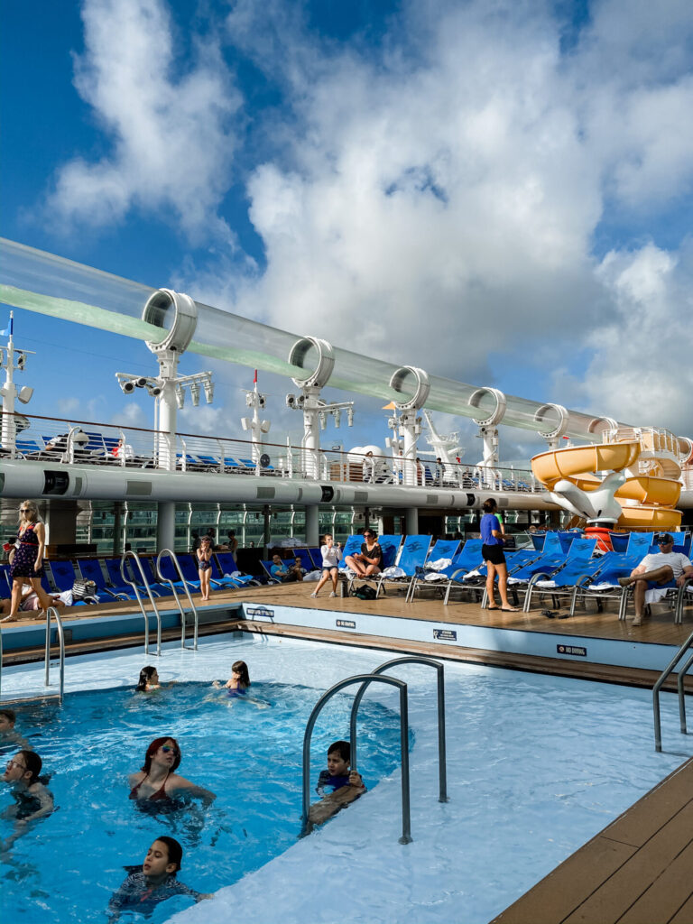 Disney Creators Celebration by popular Nashville lifestyle blog, Hello Happiness: image of a swimming pool and water slide on a Disney Cruise ship. 