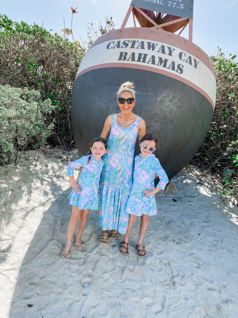 Disney Creators Celebration by popular Nashville lifestyle blog, Hello Happiness: image of two young girls and their mom standing together at Castaway Cay Bahamas and wearing a Camelia Cover-Up Maxi and Cooke Cover-Up Dresses.