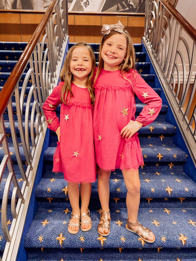 Memorial Day Sales by popular Nashville fashion blog, Hello Happiness: image of two young girls standing next to each other and wearing matching Matilda Jane Twinkling Stars dresses. 