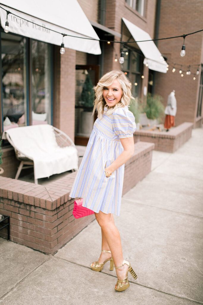 Cute Spring Shoes by popular Nashville fashion blog, Hello Happiness: image of a woman wearing a English Factory Striped Puff-Sleeve Dress, Nordstrom Small Loulou Leather Shoulder Bag SAINT LAURENT, and Jessica Simpson Mishka Metallic Croco Embossed Platform Dress Sandals. 