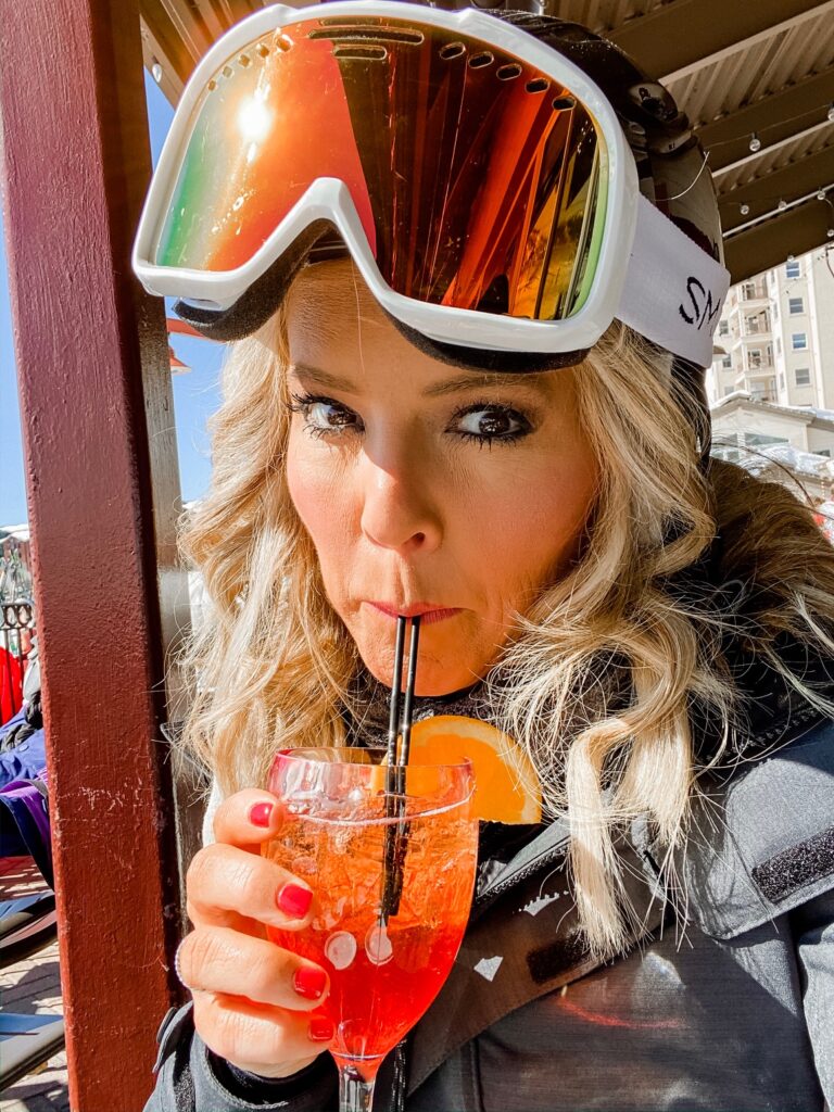 Year in Review by popular Nashville lifestyle blog, Hello Happiness: image of Natasha Stoneking wearing ski gear and drinking an alcoholic beverage outside. 